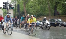 Many cyclists on busy city road