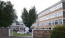 Front of 70s secondary school building with trees